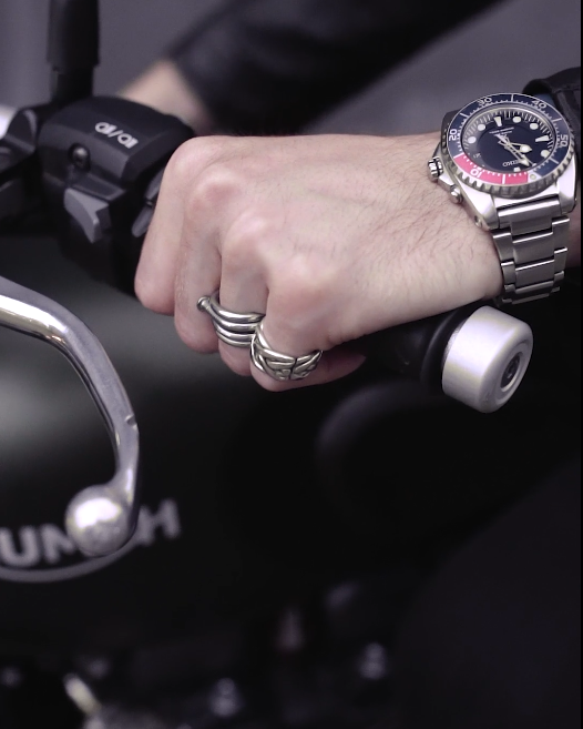 man watch on wrist riding motorcycle